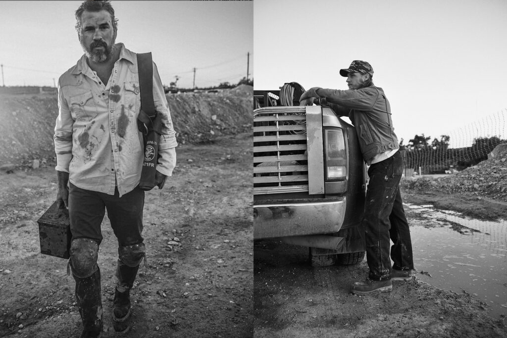 A construction worker holding his muddy helmet and standing for a portrait.